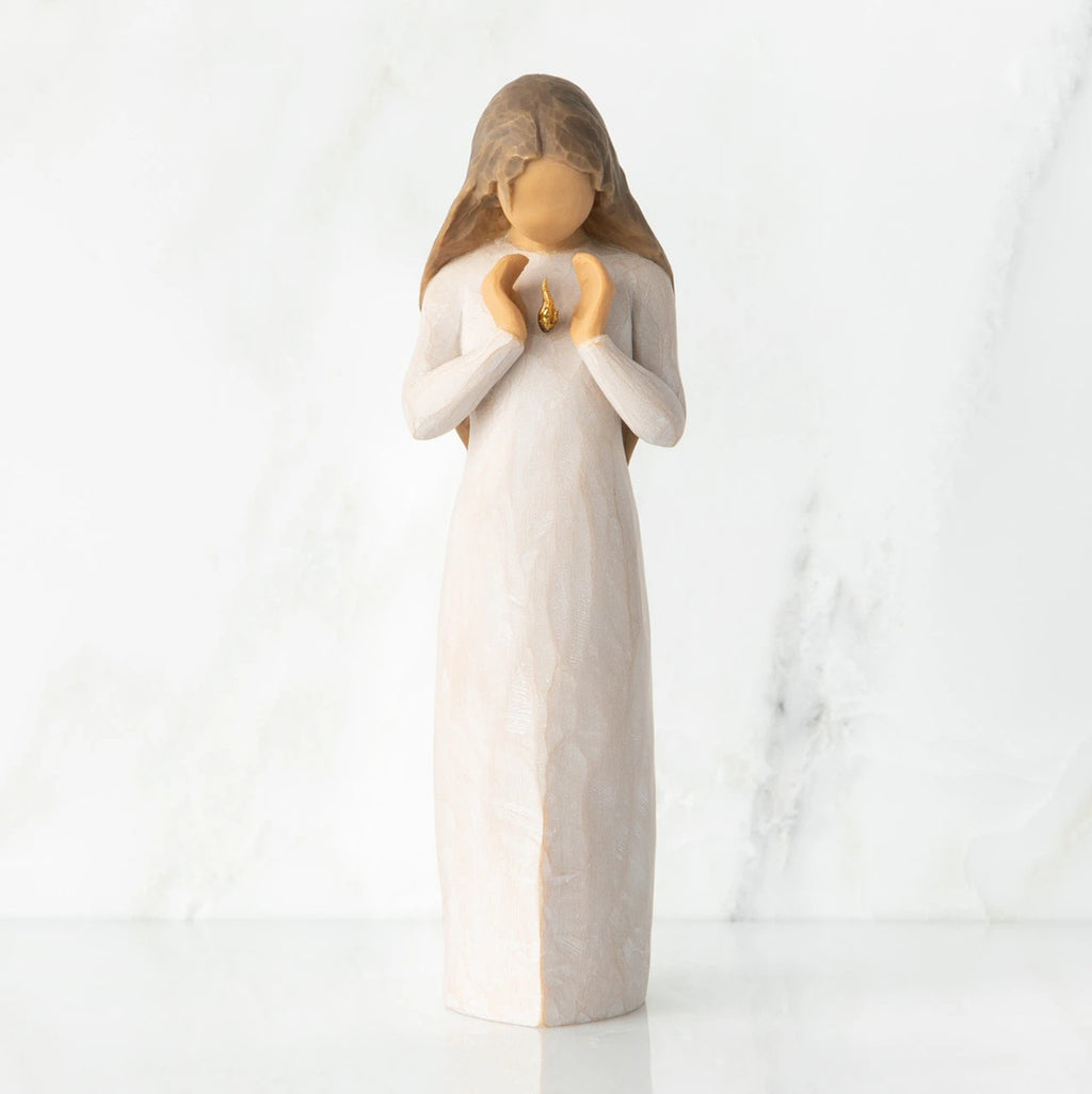 Front view, standing female figure in cream dress, hands surrounding small gold-leaf flame on chest