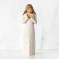 Front view, standing female figure in cream dress, hands surrounding small gold-leaf flame on chest
