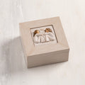 Cream wood box with hinged lid. Inset bas-relief plaque of two seated girls, facing each other.