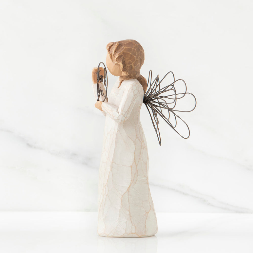 Right side view of angel with tied back brown hair, holding up a circular wire sign that says "thank you"