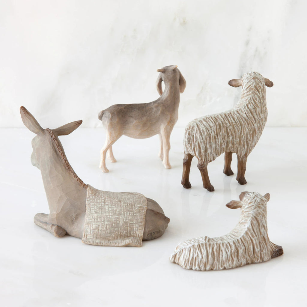 Set of two white sheep figurines next to donkey and goat figurine