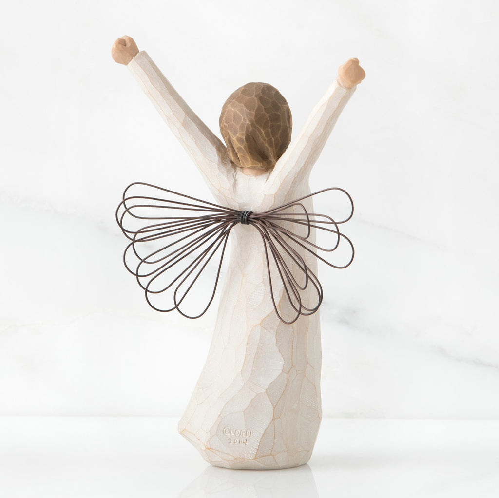 Back view of brunette angel figurine in white dress with brown wire wings