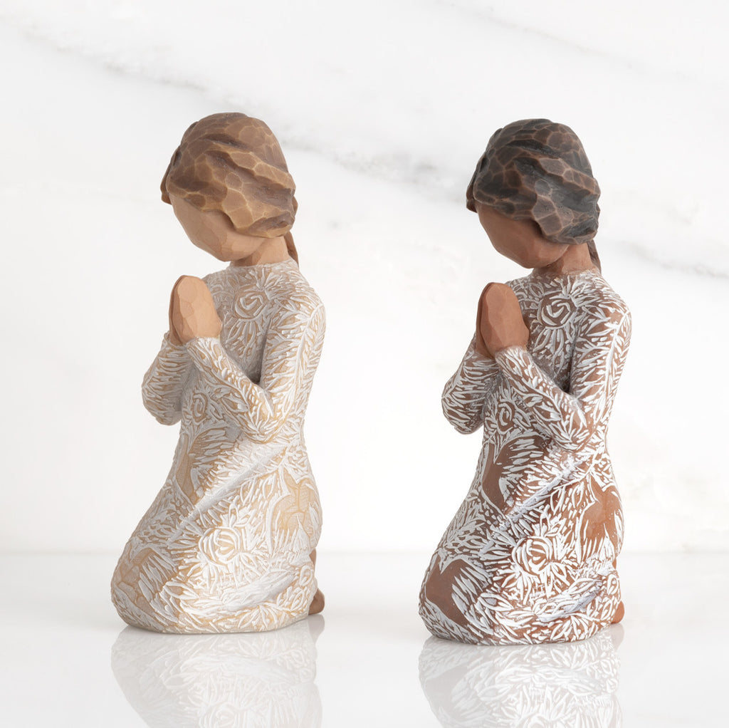 Lighter & Darker skin Kneeling figures, hands in position of prayer or meditation in cream dress carved with icons of nature, lighter and darker skin versions