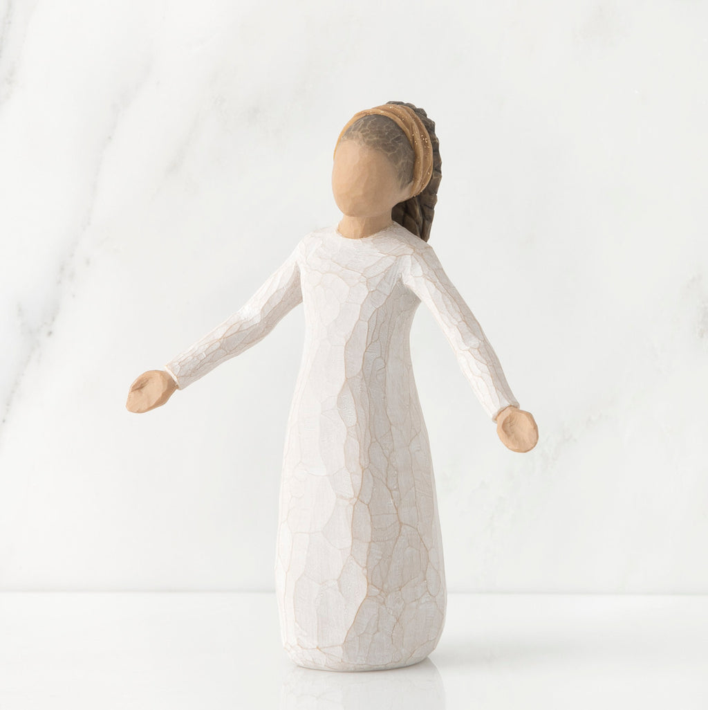 Young faceless girl figurine standing wearing all white dress with her arms out