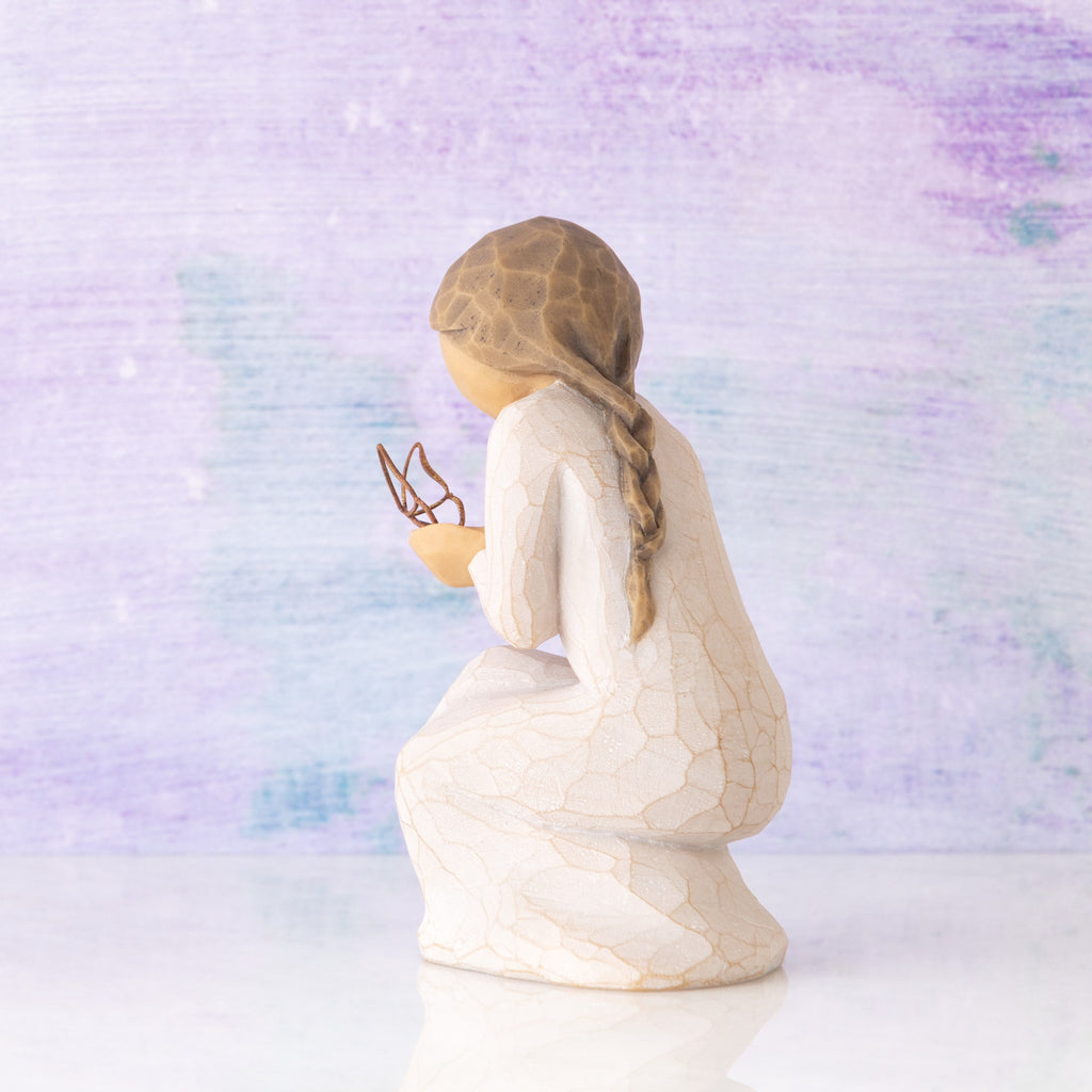 Willow Tree Quiet Wonder, 3.5”h hand-painted resin figure, kneeling in cream dress with gold leaf wire butterfly on extended hands, in front of lavender painting