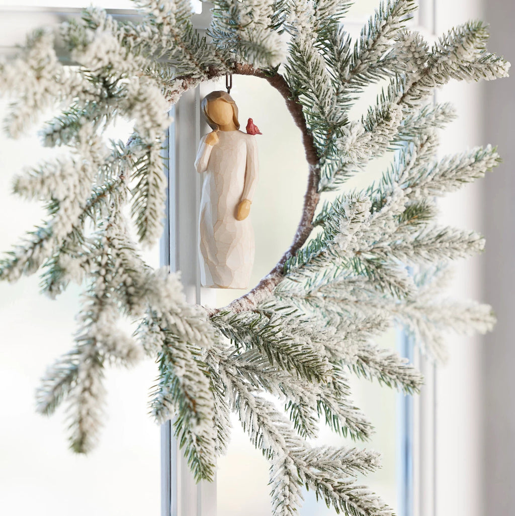 Willow Tree Messenger Ornament, 4”h hand-painted resin figure in cream dress with red cardinal on shoulder, brown elastic cord, hanging inside winter wreath